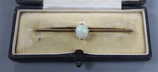 An early 20th century 9ct and white opal set bar brooch, 6cm.